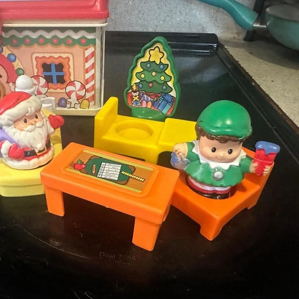 Vintage Fisher Price Christmas playset with Santa, reindeer, and gingerbread